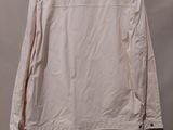 a white jacket hanging on a hanger against a white wall