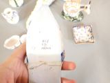 a person holding a white vase with a blue and white design on it