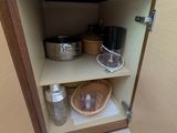 a cabinet with pots and pans inside of it