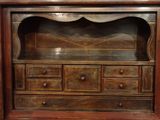 a wooden cabinet with drawers and drawers on it