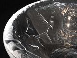 a silver bowl with a clock on it sitting on a table