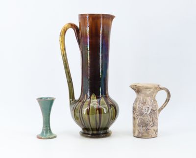 three vases sitting next to each other on a white surface