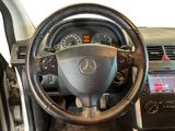 a steering wheel and dashboard of a car in a room