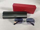 a close up of a pair of sunglasses on a table next to a red box