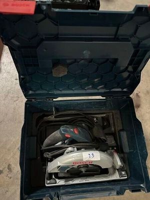 a tool box with tools inside of it on the floor