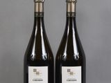 two bottles of wine sitting on top of a table next to each other