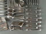 a lot of silver spoons and spoon spoons on the table
