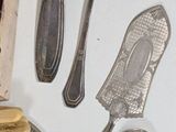 a lot of silver spoons and spoons on the table