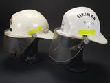 two white hard hats with yellow tape on them