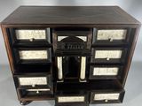an image of a black and white chest of drawers with drawers