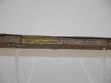 a close up of a rifle with a brass plate on it ' s side