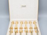 a box that has a bunch of gold toothbrushes in it