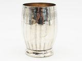 a silver cup that is sitting on a table