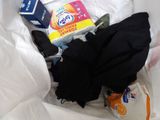 a pile of clothes and other items in a plastic bag
