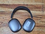 an image of a pair of headphones sitting on top of a wooden table