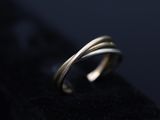 a close up of a silver ring on a black surface
