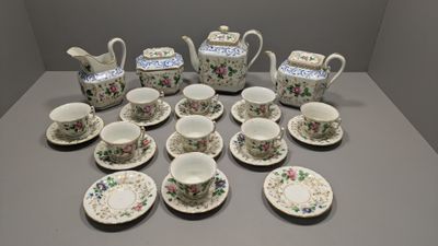 a lot of cups and saucers on the table