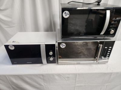 two microwaves that are sitting on a white table