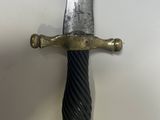 a knife that is hanging on the wall next to a wall