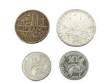 four different types of coins are shown on a white surface