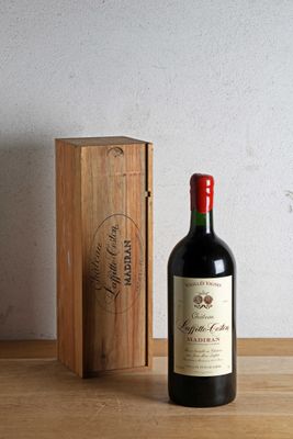 a bottle of wine sitting next to a wooden box