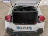 a white car with its trunk open in a parking lot