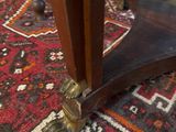 a cat that is sitting on a rug on the floor