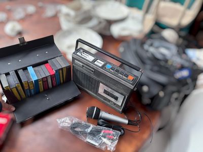 a radio, cassette player, and other items on a table