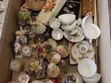 a cardboard box filled with assorted items on the floor