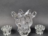 a glass vase with three pieces of glass in it