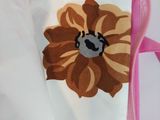 a bag with a flower on it sitting on a table