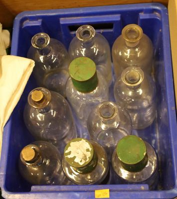many empty bottles in a blue box on the floor