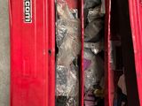 a red toolbox filled with assorted items on the floor