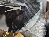 a clock that is wrapped in plastic on the bed