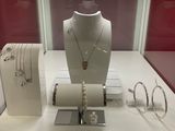 a display of necklaces and bracelets on display in a glass case