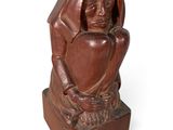 statue of a woman holding a heart on a wooden base