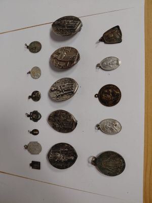 a man standing in front of a wall with a bunch of coins on it