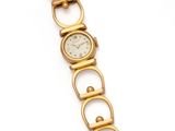 a close up of a gold watch on a white background
