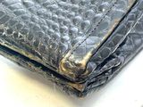 a black wallet sitting on top of a white table