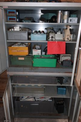 a metal cabinet with many different items in it