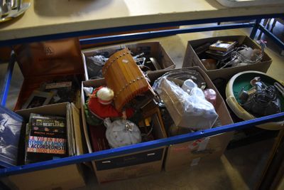 boxes of assorted items are sitting on a table in a room