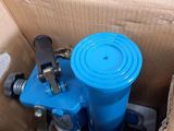 a box with a blue water pump inside of it
