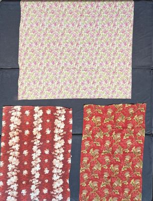 four pieces of fabric are laid out on a table