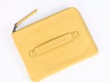 the yellow leather wallet is open on a white surface