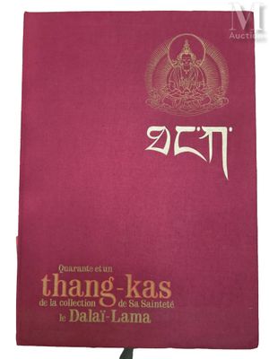 a red book with gold lettering and a buddha image on it