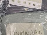 two sheets of bedding wrapped in plastic on a table