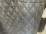the back of a black jacket with a diamond pattern on it
