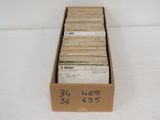 a cardboard box filled with a lot of old records