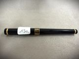 a pen with a tag on it sitting on top of a table