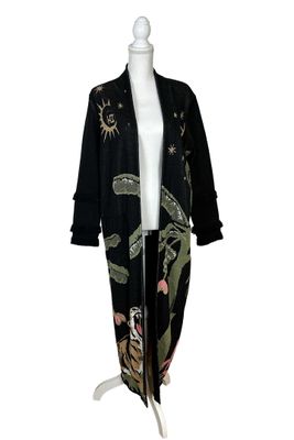 an image of a mannequin wearing a black coat with a floral design